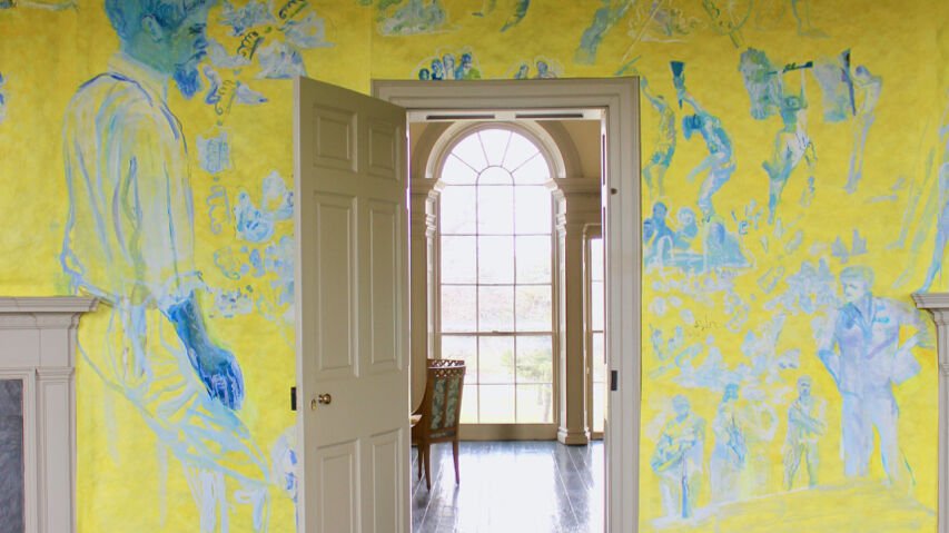 a yellow and blue room with an open door
