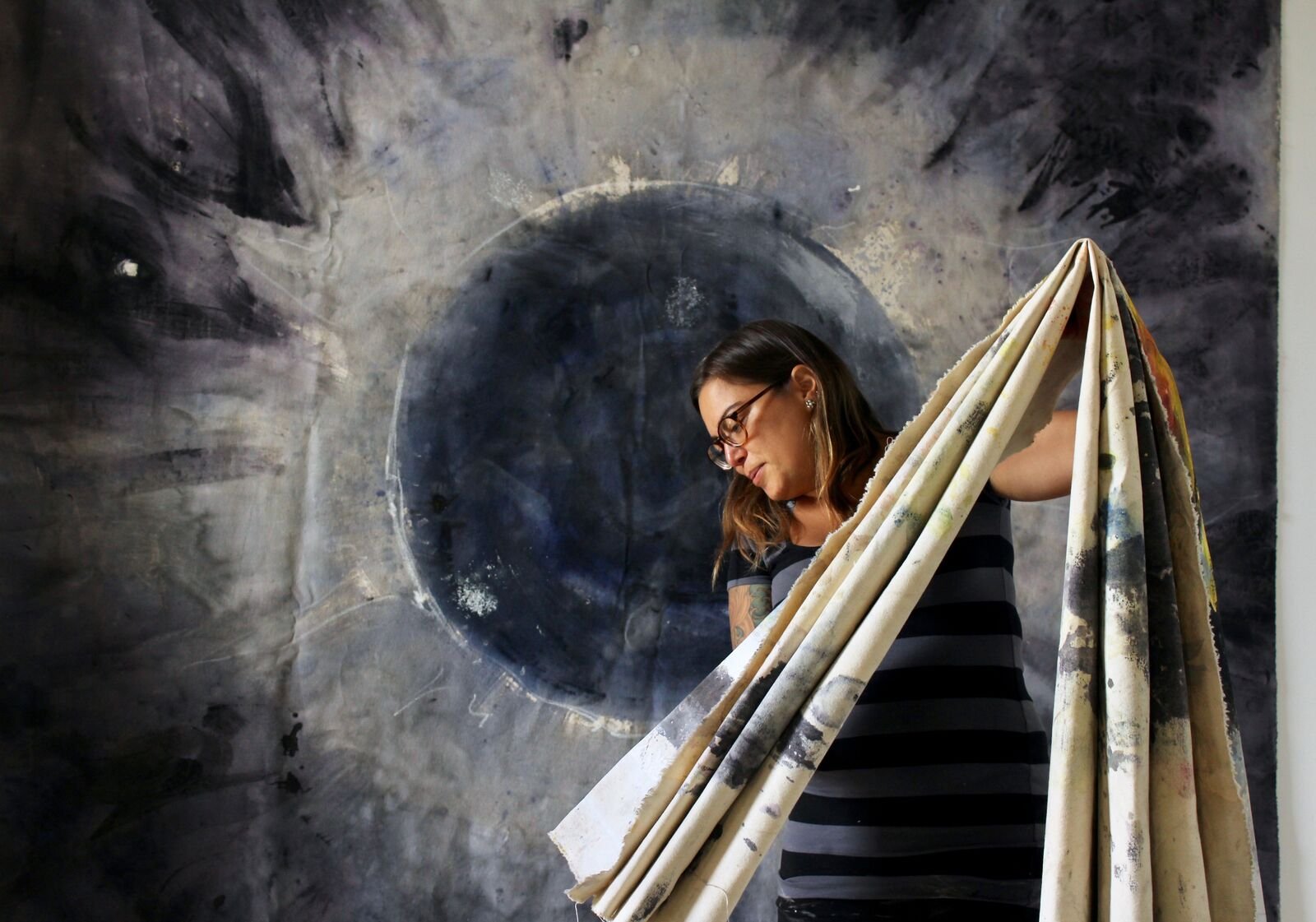 Person holding folded tapestry