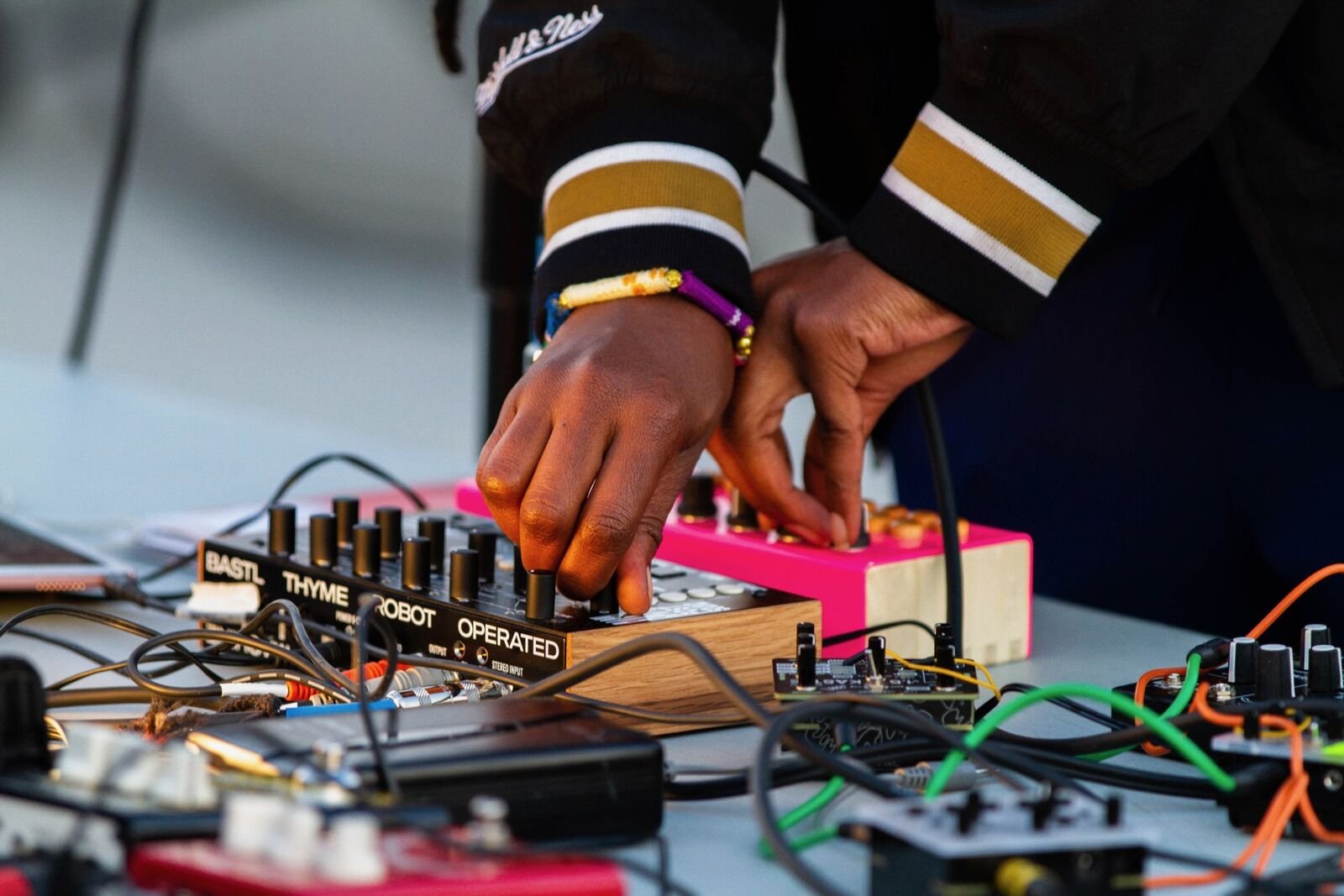 hands turn knobs of mixers as a person djs