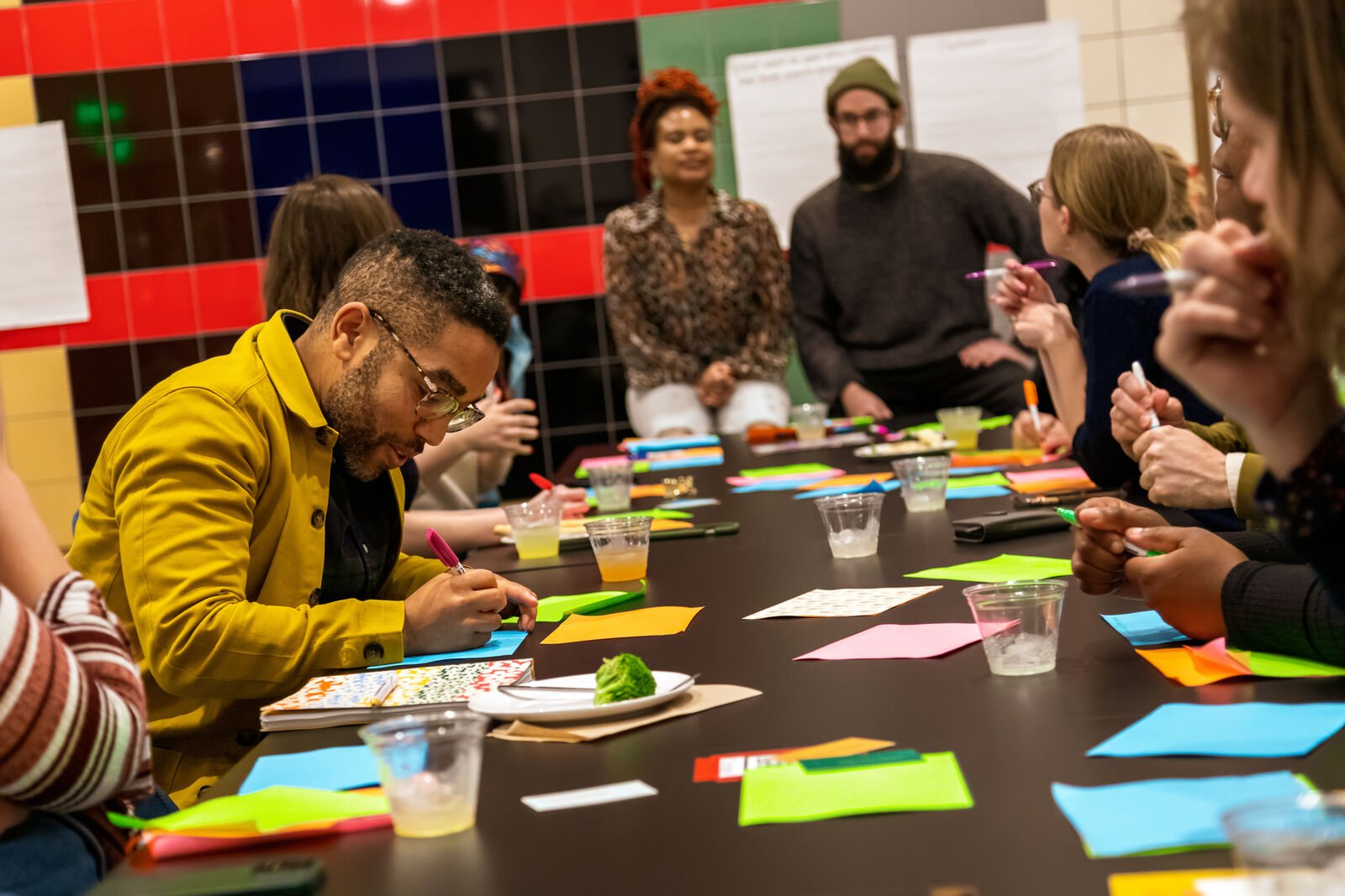 Rising Wing members at a table filling out cards