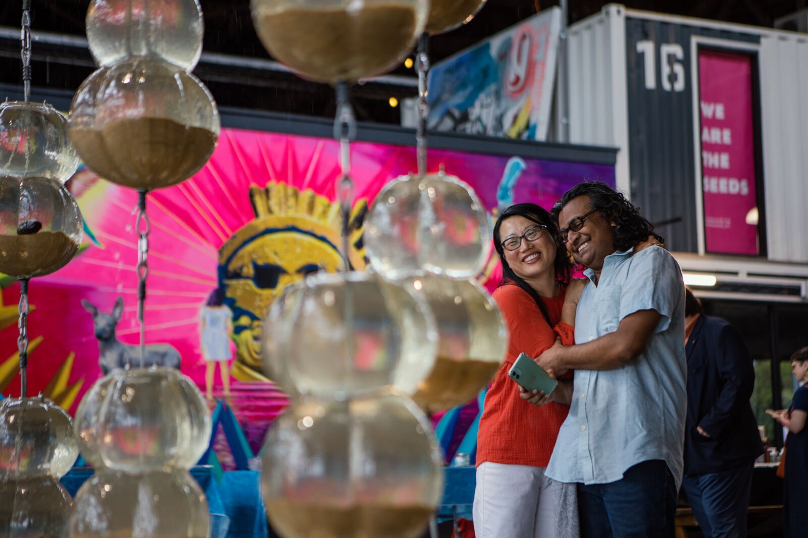 Artist Jean Shin hugs a guest during the opening reception